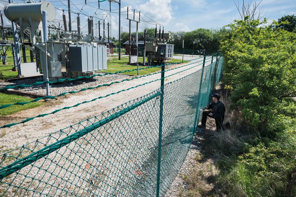 Critical infrastructure - man attempting to climb perimeter fence